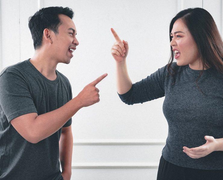 man in gray crew neck long sleeve shirt standing beside woman in black crew neck shirt