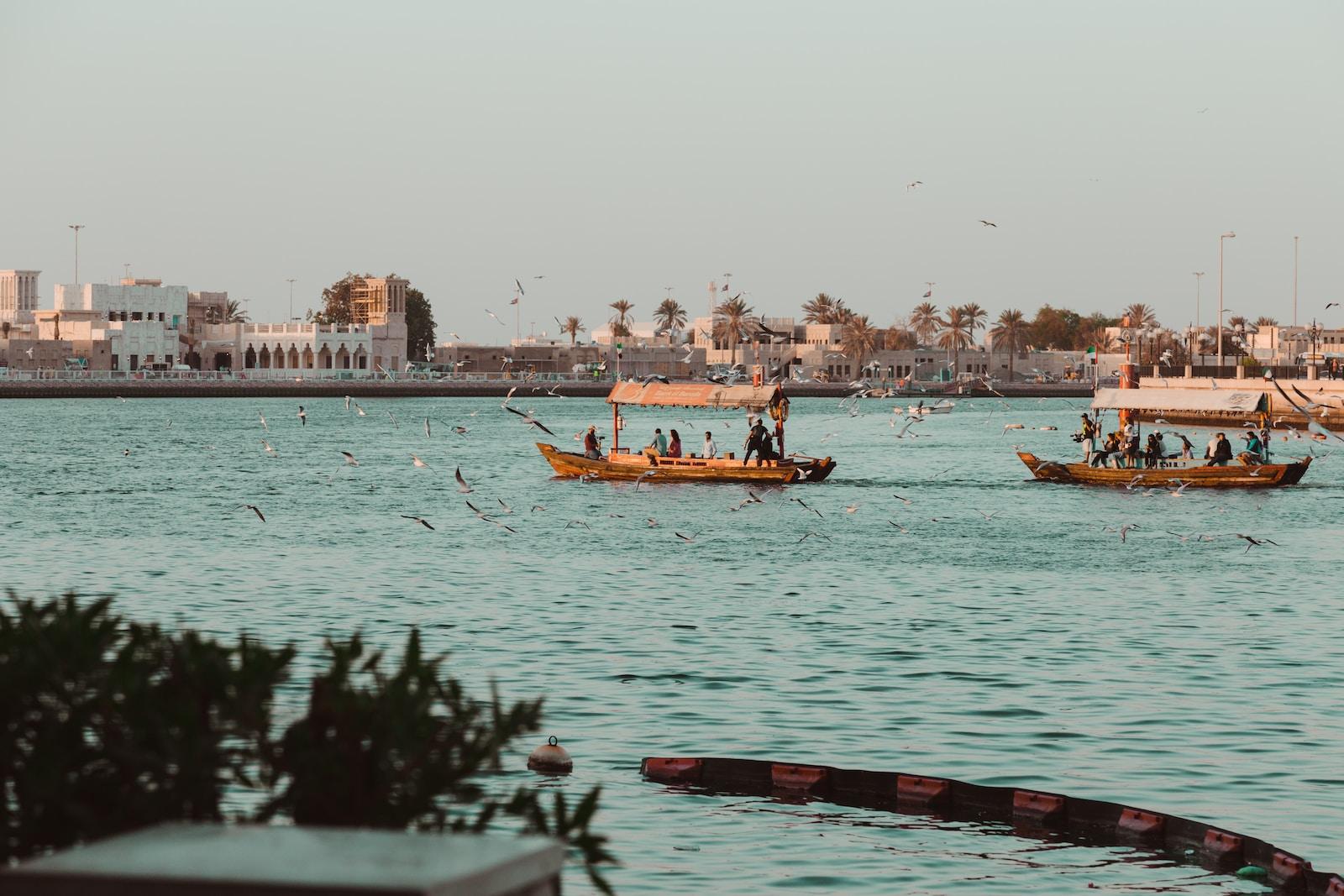 people on boat near buildings at daytime
