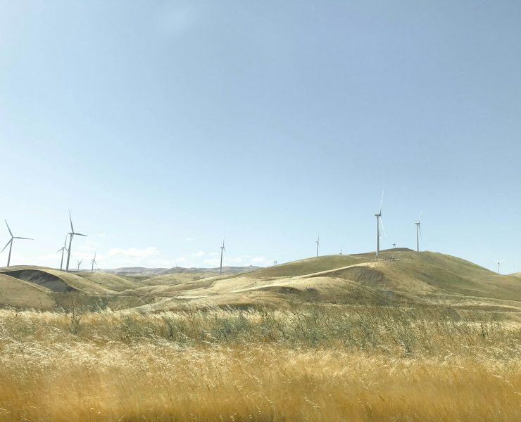 white wind mills on hill