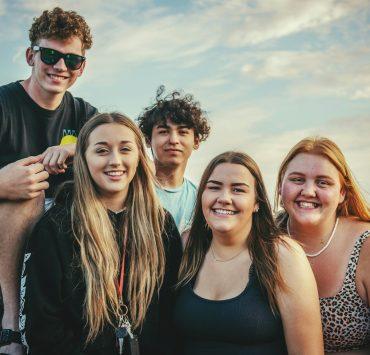 photography of five people near outdoor during daytime