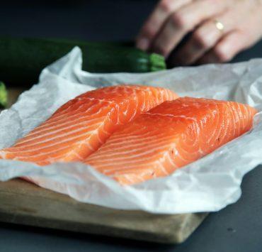 raw fish meat on brown chopping board