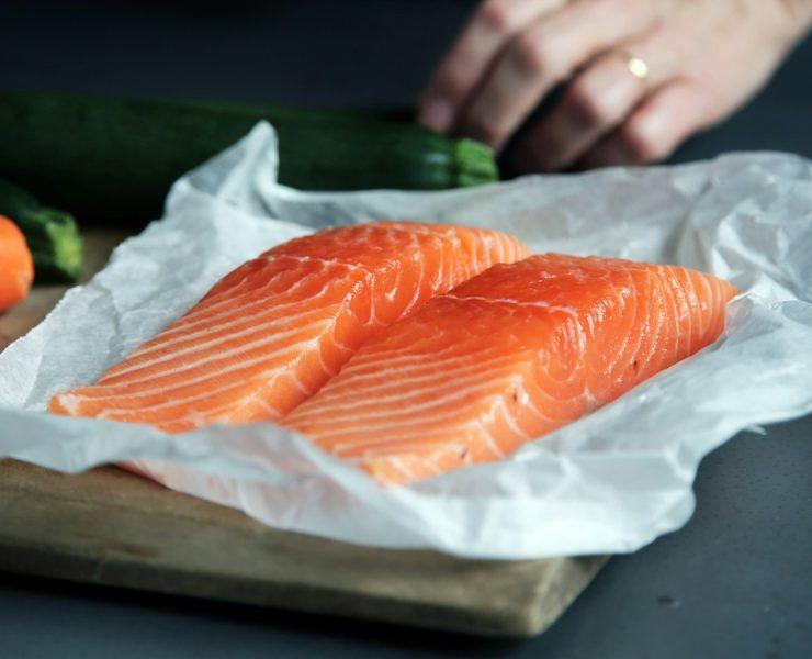 raw fish meat on brown chopping board