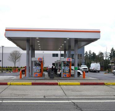 a gas station with cars parked in the lot