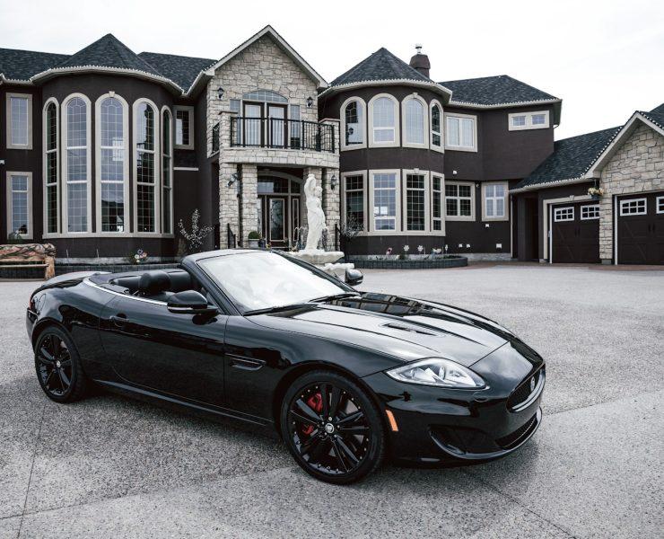 black convertible coupe parked near house