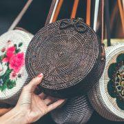 person holding brown sling bag