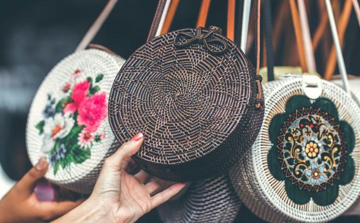 person holding brown sling bag