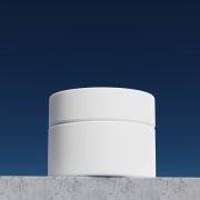 a white cylindrical object sitting on top of a wall