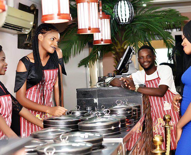 Three Woman and Man Wearing Apron