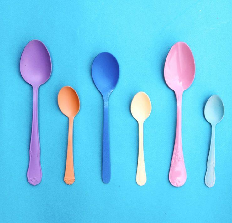 pink plastic spoon on pink and white polka dot textile
