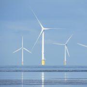 a group of wind turbines in the ocean
