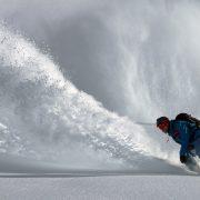 person gliding in snow during day time