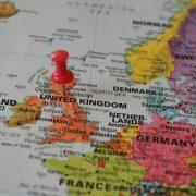 A red pin is placed on a map of europe